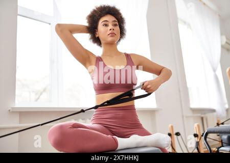 Sporty woman engaging in pilates exercise. Stock Photo