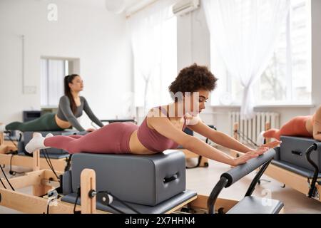 Sporty women practicing pilates in a gym. Stock Photo