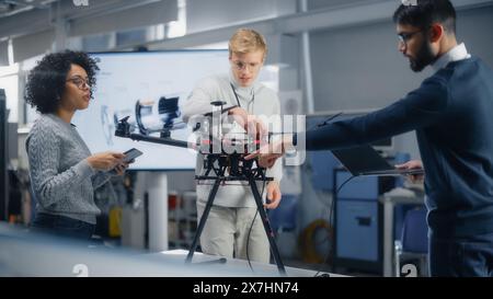 Diverse Aviation Engineers Building, Setting Up, Configuring and Testing Drones As Their Job at Modern Factory. Aviation Industry and Innovative Technological Startup Concept. Stock Photo