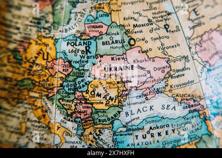 A vintage globe showing the detailed geography of Eastern Europe, highlighting countries like Ukraine, Poland, Russia, and the surrounding regions. Stock Photo