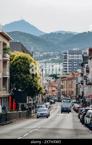 Clermont-Ferrand, France - 21 June 2023 : Beautiful street in the heart of Clermont Ferrand, with the Puy de Dome behind Stock Photo