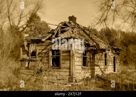 An old wooden house abandoned by residents, passing away life. Reflection on the passing time Stock Photo