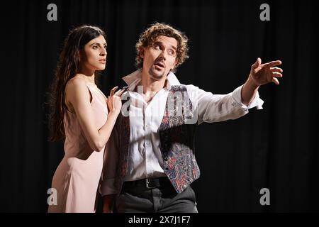 A man and woman performing on stage during rehearsals. Stock Photo