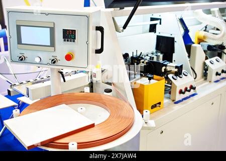 Single sided automatic edge banders on factory Stock Photo