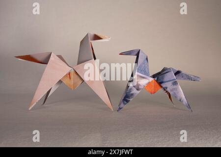 Paper origami of two horses on a white background Stock Photo