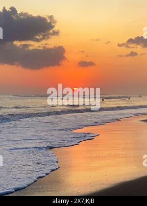 Beautiful sunset with pink clouds on Bali beach Stock Photo