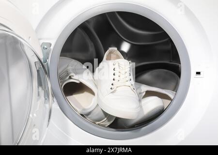 Stylish clean sneakers inside modern washing machine Stock Photo