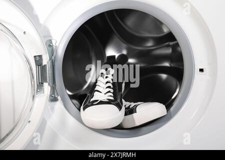 Stylish clean sneakers inside modern washing machine Stock Photo