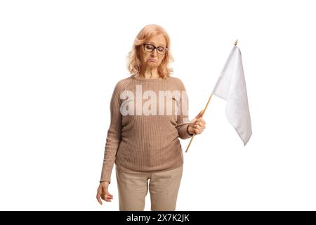 Sad middle aged woman holding a white flag isolated on white background Stock Photo