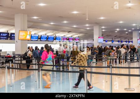 Auckland, New Zealand - February 21, 2024: Passengers checking in for their flights at Auckland International Airport. Stock Photo