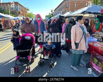 Men with henna colored beards and hair doing business at Bangladeshi street fair in the Kensington section of Brooklyn, New York Stock Photo