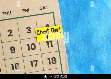 Cheat day concept. Written reminder note on a calendar. Stock Photo