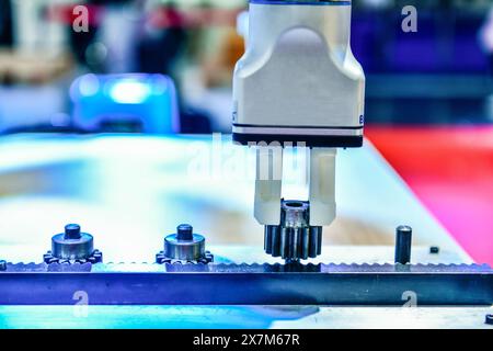 Modern Robot Arm automation system moving metal gear parts in factory, industrial robot concept Stock Photo
