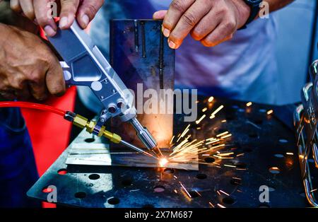 Industry worker welding iron pieces work at the factory Stock Photo