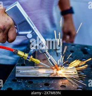 Industry worker welding iron pieces work at the factory Stock Photo