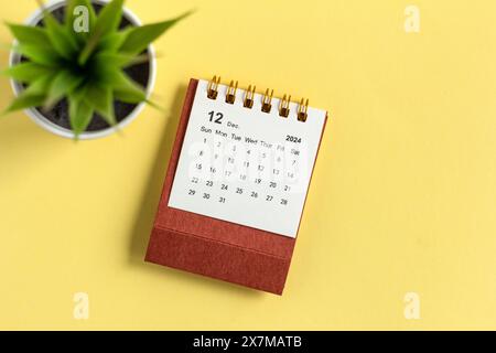 December 2024. Monthly desk calendar for 2024 on a yellow background Stock Photo