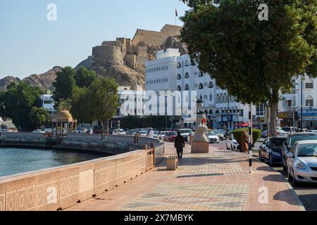 Muscat, Oman - January 2, 2024: The historic fort oversees a modern Muscat as locals navigate the blend of old and new. Stock Photo