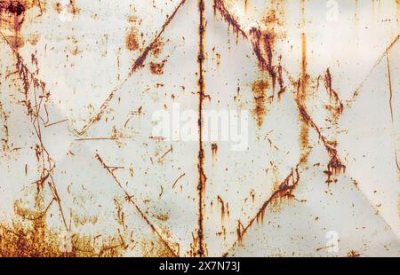 Metal wall painted white. Metal background with streaks of rust. There are rust stains on the metal surface Stock Photo