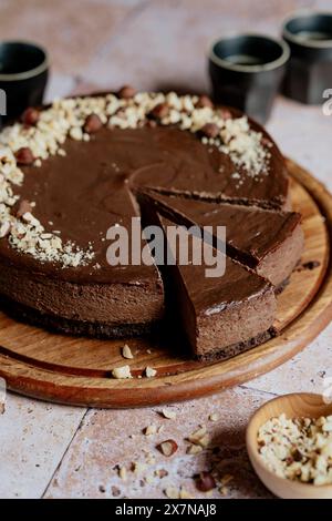 Chocolate cheesecake slices with hazelnuts and coffee on tiles Stock Photo