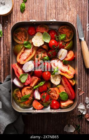 Fresh tomatoes with garlic, shallot and basil Stock Photo