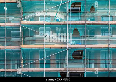 Scaffolding with debris netting on London street, England Stock Photo