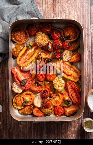 Baked fresh tomatoes, garlic, shallot, basil Stock Photo