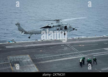 240519-N-TB177-1040 PACIFIC OCEAN (May 19, 2024) An MH-60S Sea Hawk helicopter, assigned to Helicopter Sea Combat Squadron (HSC) 14, takes off from th Stock Photo