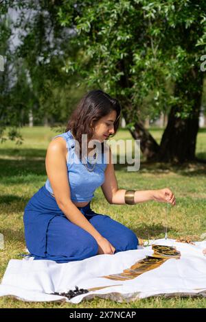 Latin woman reading tarot cards with a pendulum Stock Photo