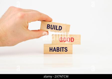 Business, psychological and build good habits concept. Build good habits symbol it is laid out by hand on wooden bars Stock Photo