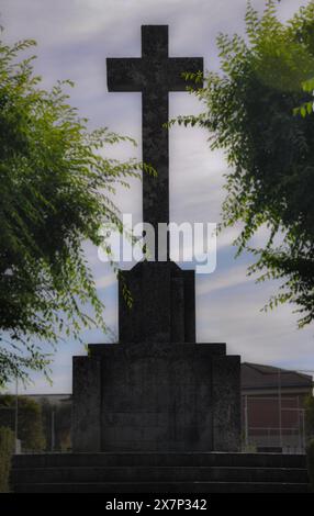 Old cross of the fallen among shadows, old symbols of Franco's regime, Spanish Civil War, Garrovillas de Alconétar Stock Photo