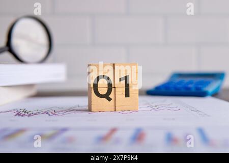 Close up image of wooden cubes with alphabet Q1 on office desk. First quarter concept. Stock Photo