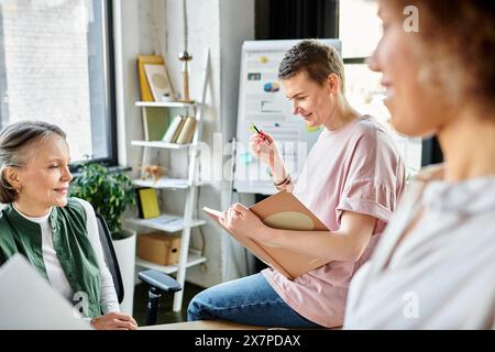 Diverse group of hardworking businesswomen collaborating around a table in a coworking space. Stock Photo
