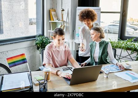 Three hard-working women collaborate at a table in a modern office setting. Stock Photo