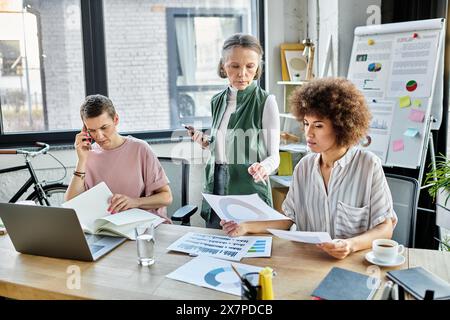 Hard working diverse businesswomen, including members of the LGBT community, working together in an office. Stock Photo