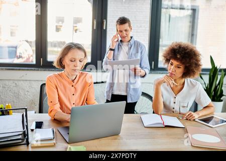 A diverse group of hardworking businesswomen collaborating around a wooden table. Stock Photo