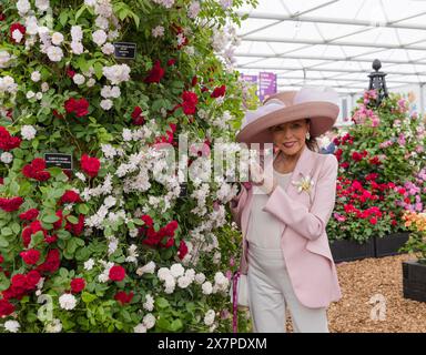 Actress Dame Joan Colllins posing with roses on the Peter Beales Roses stand at RHS Chelsea Flower Show 2024. Stock Photo