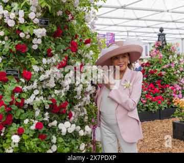 Actress Dame Joan Colllins posing with roses on the Peter Beales Roses stand at RHS Chelsea Flower Show 2024. Stock Photo