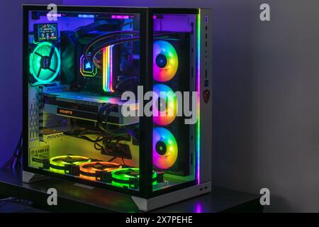 Adelaide, Australia - December 24, 2023: Close-up view of modern gaming PC in glass case with RGB glowing LED lights, CPU water cooling and NVidia GeF Stock Photo