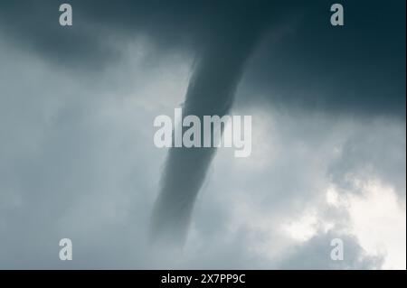 A tornado coming out of a supercell in Europe. A tornado is a violently ...
