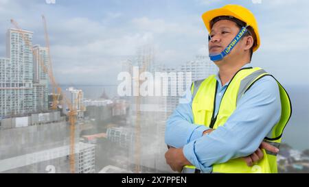 Civil engineer architect standing holding a safety helmet on construction site background, Construction site plans to build high-rise buildings, Engin Stock Photo