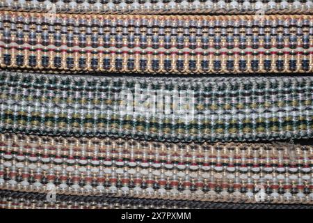 Decorative braid - woven multi-colored threads. Braid is a narrow woven or braided strip or cord, usually having only 1 system of obliquely woven Stock Photo