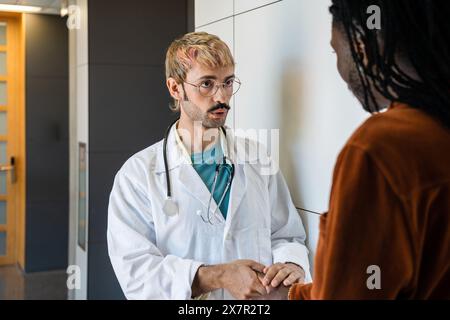 A dedicated doctor explains hypoglycemia symptoms and management to a concerned patient in a modern hospital setting, providing both advice and comfor Stock Photo