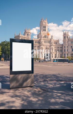 Blank billboard mockup in Madrid with the Cibeles Palace in the background under a clear sky Stock Photo