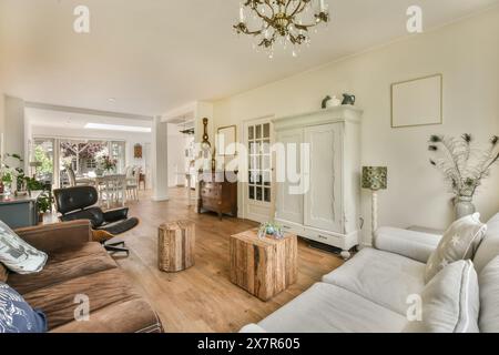 This beautifully furnished living room features classic decor with a modern touch, located in the Schaarweg region of Amsterdam The space includes a w Stock Photo