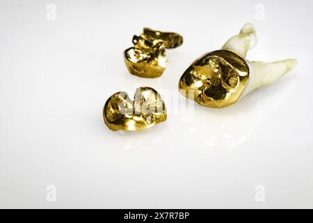 Cut out of used dental crowns made of gold Stock Photo