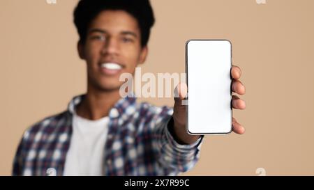 Black guy showing blank cellphone screen, closeup Stock Photo