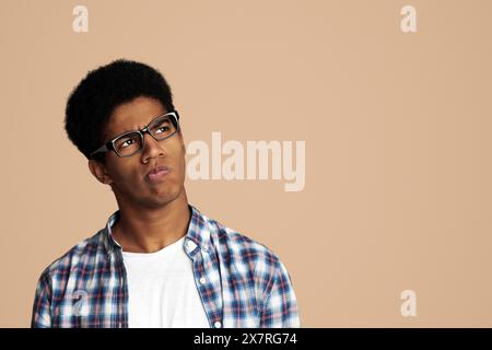 Thoughtful Afro Guy Thinking and Looking Aside Stock Photo