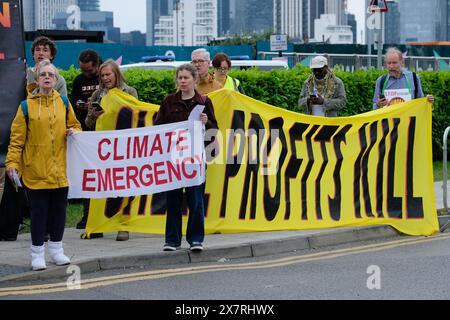 London, UK, 21st May, 2024. Climate activists from Fossil Free London, Extinction Rebellion and others staged a protest outside the AGM for Shell in North Greenwich, against destructive oil and gas projects causing environmental harm and climate breakdown. A number of activists entered the AGM, caused disruption, and were later removed by security staff.  Credit: Eleventh Hour Photography/Alamy Live News Stock Photo