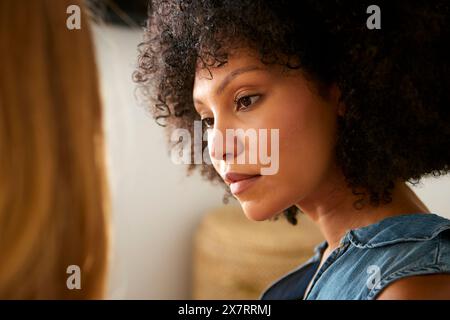 Close Up Shot Of Two Female Friends Having Serious Conversation At Home Together Stock Photo
