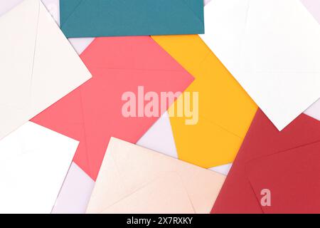 Multicolored envelopes scattered on a blue background. Creative background. Stock Photo